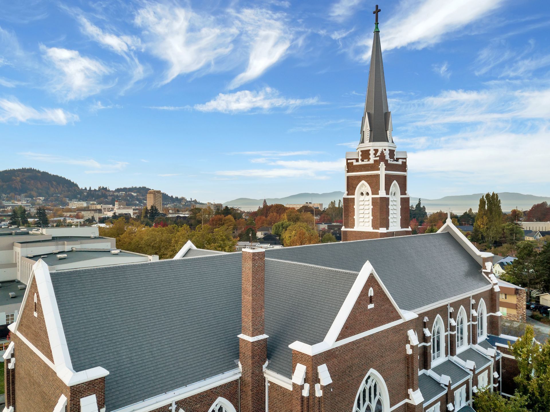An aerial view of a large brick church with a steeple